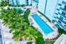 Expansive outdoor amenities featuring a lap pool with lane markers, an additional freeform pool, and a circular spa