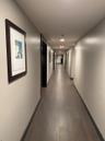 Corridor featuring wood-finish flooring, light-toned walls, and recessed lighting