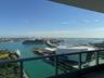 Expansive water and city views from a private balcony with a glass and metal railing