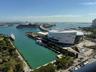 Expansive water frontage with marina access, featuring a large cruise ship, surrounding cityscape, and a prominent arena structure