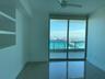 Floor-to-ceiling glass sliding doors provide access to an outdoor balcony