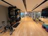 Dedicated fitness area featuring light wood-finish flooring