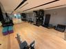 Dedicated fitness space featuring wood-finish flooring and full-height mirrored walls