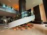 Grand foyer featuring a contemporary spiral staircase with glass railings
