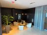 Elegant common area featuring dark paneled walls, polished tile flooring, and integrated ceiling lighting