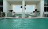 Architectural pool deck with a curved perimeter, offering a broad cityscape and water panorama