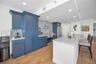 Cucina Features Versay Grand Blue Encaustic Style Porcelain Tile Backsplash, Stainless appliances, Quartz Counter Surfaces, Custom Shaker Style Cabine