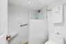 LARGE WALK-IN SHOWER OFF THE PRIMARY SUITE FEATURES A BUILT IN  BENCH FOR ADDED COMFORT AND RELAXATION.