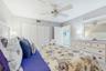 SPLIT FLOOR PLAN FEATURES SECOND BEDROOM OFFERS KING SIZE BED, CEILING FAN, AND FLAT TV.