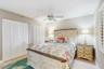 THIRD BEDROOM FEATURES DOUBLE CLOSETS, QUEEN SIZE BED, PLANTATION SHUTTERS, FLAT TV, AND CEILING FAN
