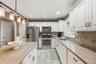 An easy flow between the kitchen and dining areas makes gathering and entertaining effortless.