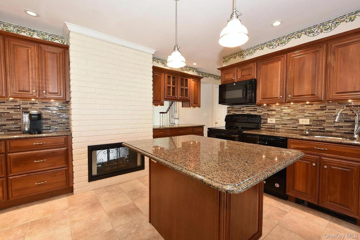 Kitchen with an Island & Double Sided Fireplace