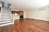 Den with engineered wood floors & recessed lights