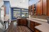 A large window over the sink brings natural light into the kitchen and provides a view toward the outdoor living area.