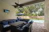 Welcome to the Florida room you’ll actually use—a covered outdoor living area overlooking the screened saltwater pool.