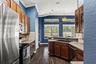 Generous cabinetry and counter space line both sides of the kitchen, creating a functional workspace with excellent storage.