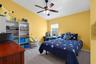 Another spacious secondary bedroom offers plenty of room for a full furniture arrangement and personal touches.