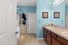 The primary bath features an extended dual-sink vanity with plenty of counter space and storage.