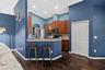 A breakfast bar adds casual seating and creates a natural transition between the kitchen and family room.