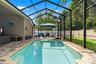 The full screen enclosure lets you enjoy the saltwater pool while still feeling connected to the surrounding outdoor space.