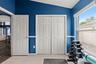 Natural light and a full closet make this flexible room equally well suited as a bedroom, fitness room, or hobby space.