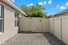 A gated side area provides additional usable outdoor space separate from the main pool and backyard areas.