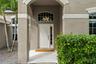The covered front entry creates a welcoming arrival, with an arched transom bringing additional natural light inside.