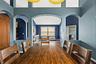 High ceilings, arched openings, and generous natural light give the main living spaces an airy, open feel.