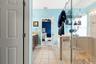 A separate glass-enclosed shower complements the primary bath’s spacious layout.
