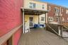 Expansive wooden deck with a covered outdoor area, providing access to the property's exterior