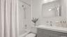 Refreshed hall bath features a modern vanity and updated fixtures.