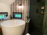 5' round soaking tubtile has radiant heat and open shower