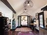 main living area vaulted and crate and barrel light fixtures with a clear view into the bedroom