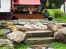 Waterfall pond with stone bridge greets you as you walk into the home