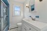 First floor bathroom with updated Vanity with integrated sink, white cabinetry and tub/shower ombo