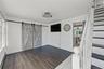 view from the front door features vinyl flooring, stylish barn doors that hide a large closet perfect for a workspace easily hidden or bar