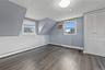 Fourth bedroom located on the second floor has two windows, bi-fold closet doors, and wall-mounted air conditioner