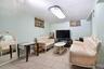 Tiled lower level Family Room with 1/2 bath and Utility Room