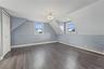 Third bedroom located on the second floor features a Sloped ceilings, two sash windows, bi-fold closet, and ceiling-mounted lighting fixture