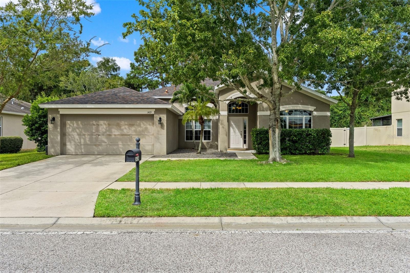 Attractive single-story curb appeal, mature landscaping, and a two-car garage welcome you home.