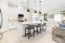 A large island with counter seating is an inviting place to chat with the chef