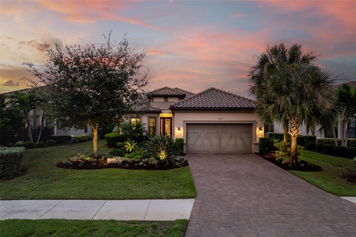 Paver driveway and custom garage door add detail