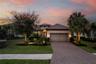 Paver driveway and custom garage door add detail