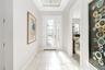Inside, the foyer hallway is filled with natural light