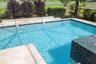 A waterfall feature adorn the decorative opposite wall of the pool