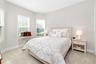 The second ensuite bedroom, in the front of the home, offers ta offers a three window bay and a full bath with a tub/shower combination.