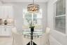 The dining area overlooks the lanai and windows offer an abundance of natural sunlight