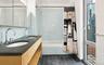 Bathroom with double vanity, tiled shower / bath combo, and a sink