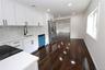 Kitchen featuring white shaker cabinetry, white countertops, a mosaic tile backsplash, dark wood-finish flooring, and recessed lighting