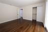 Hardwood flooring, painted walls, white trim, sliding closet doors, and recessed lighting